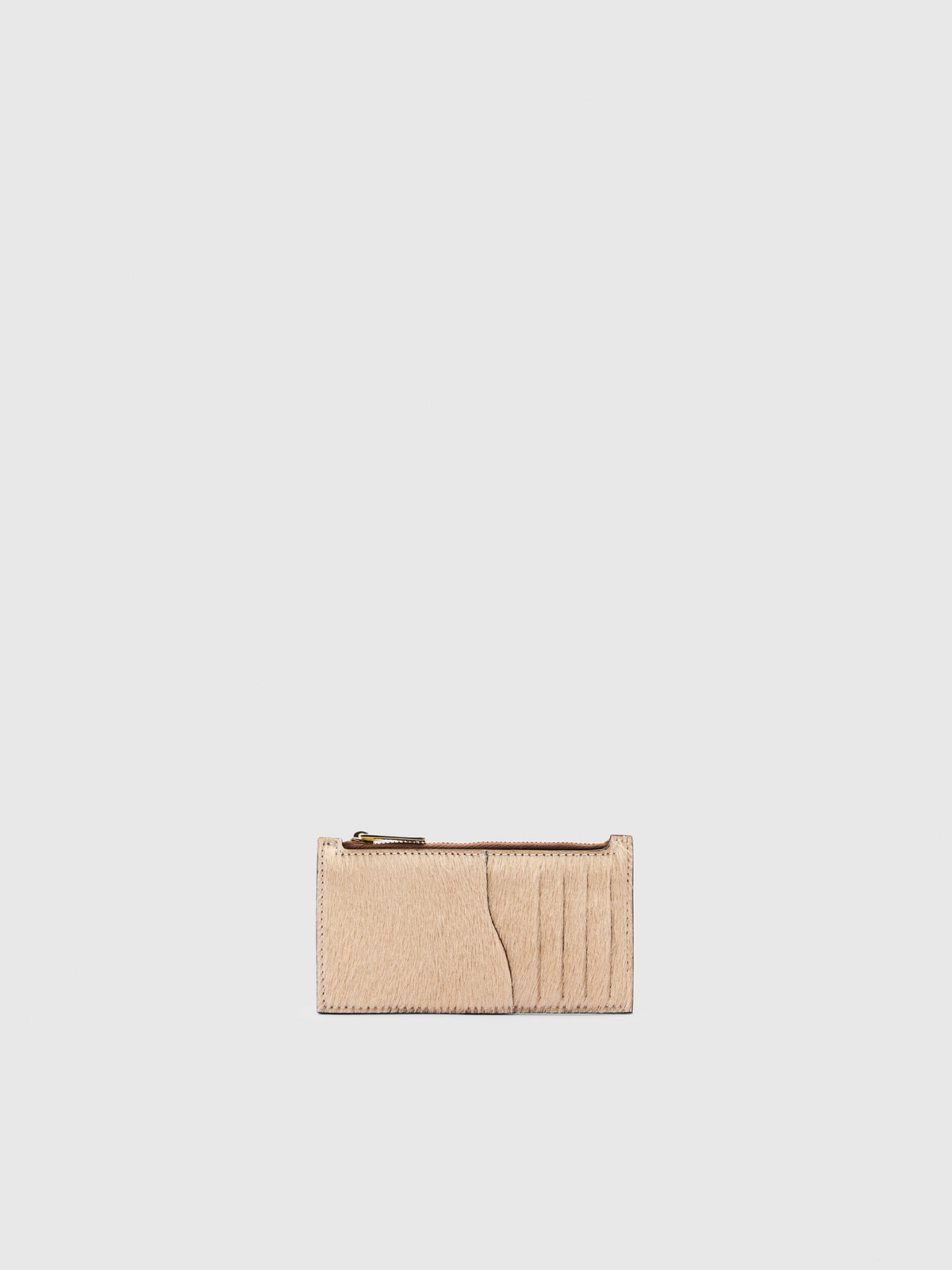 A small beige leather zip-around card holder with card slots and a gold-tone zipper pull, on a light gray background.