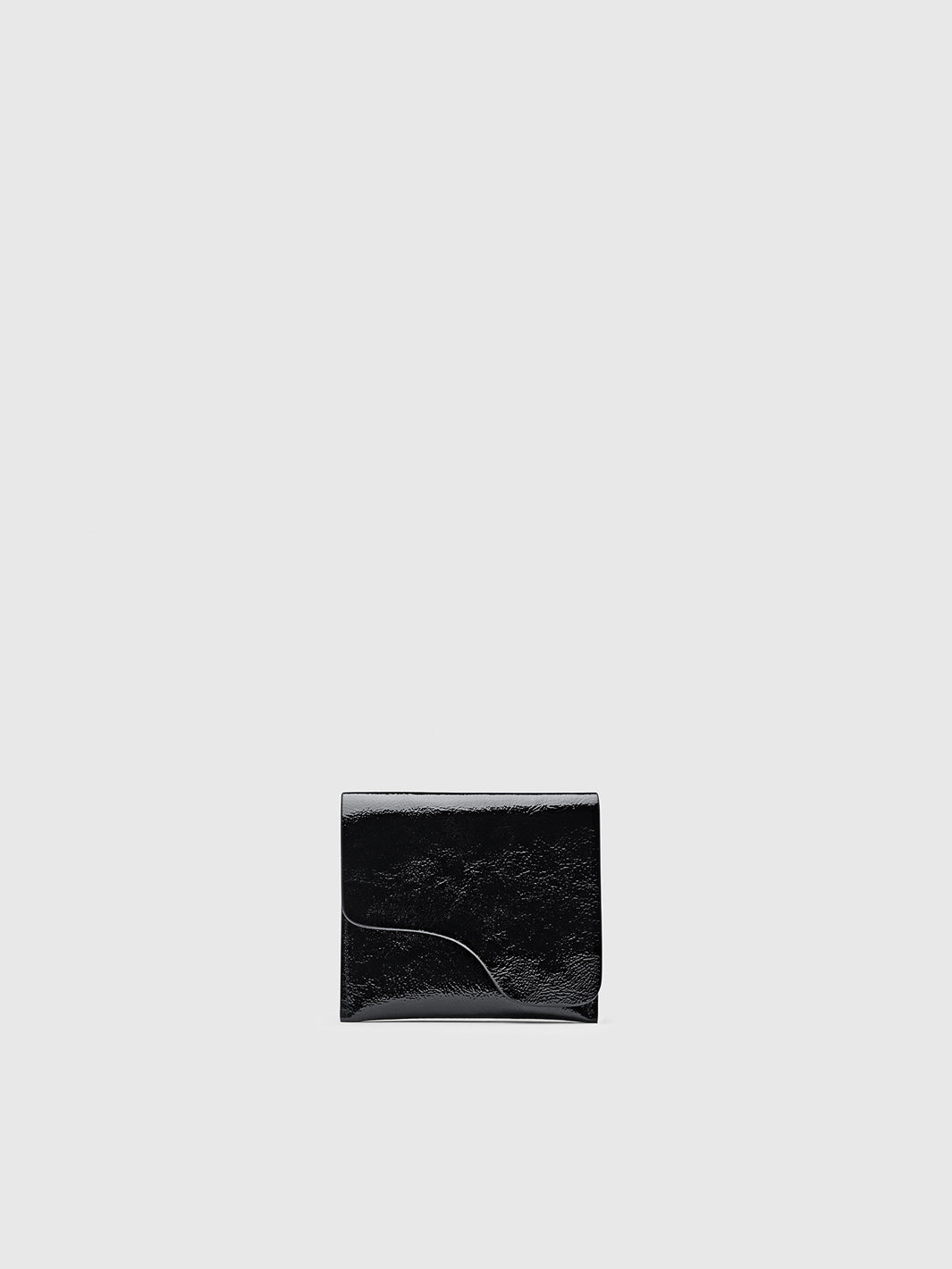 A small black leather wallet with a glossy patent finish and a curved flap, centered on a light gray background.
